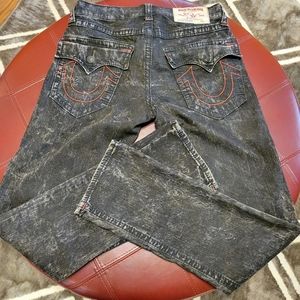 Men size 30 black stonewashed True Religion jeans with red stitching.